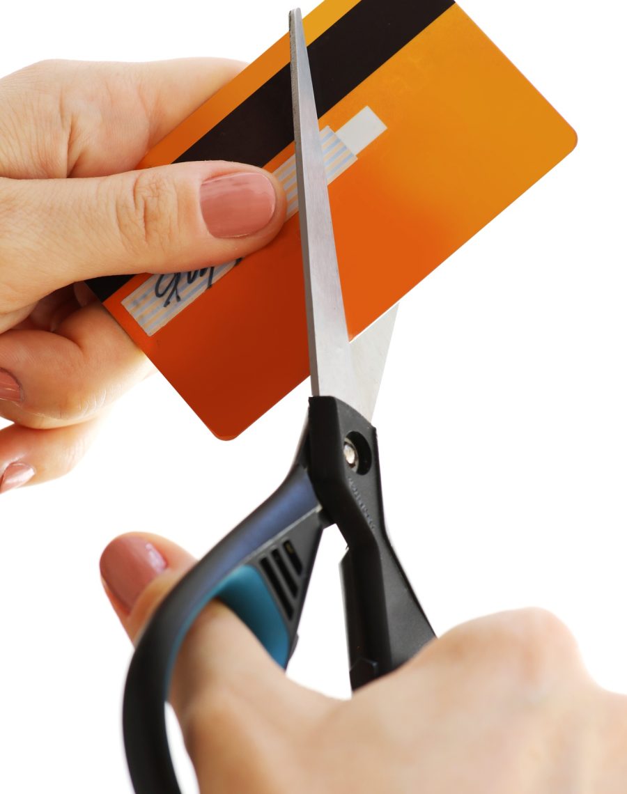 Woman cutting her credit card with a scissors